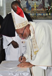 The Lord Bishop signs the Instrument of Admission