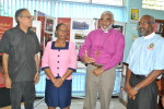 The Rt. Rev. Robert Thompson (centre), Suffragan Bishop of Kingston, discusses points highlighted in the Exhibition with (from left): Mr. John Aarons, Diocesan Archivist; Miss Paulette Benjie, Senior Librarian, St. Catherine Parish Library; and The Venerable Patrick Cunningham, Chairman, Cathedral Sunday Planning Committee.