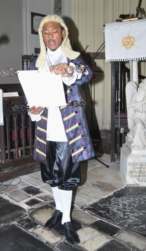 Jomo Aikens, dressed as a Town Crier, reads the 2013 Cathedral Sunday Proclamation