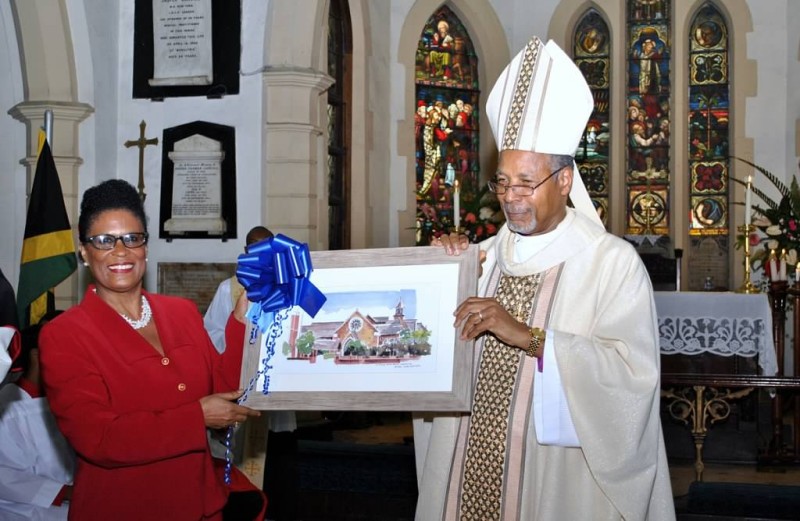 Mrs. Melrose King Smith, Secretary of the Church Committee, presents a framed print of the Church to the Archbishop. 
