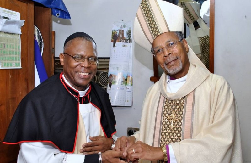 The Rev. Canon Major Sirrano Kitson, Rector, St. Andrew Parish Church, and Archbishop Holder, exchange warm greetings