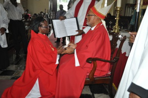 Rev. Marjorie Downer, newly-ordained Deacon, receives a copy of the New Testament from Bishop Gregory.